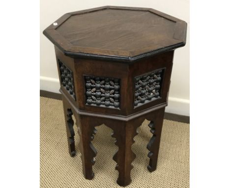 A Syrian mother of pearl and bone inlaid teak octagonal occasional table with fretwork carved decoration, 39.5 cm diameter x 