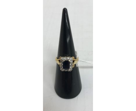 An 18-carat gold emerald cut sapphire and diamond ladies dress ring, size K 4g