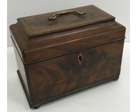 A late George III figured mahogany tea caddy, the top with brass swan neck handle opening to reveal a three section interior 