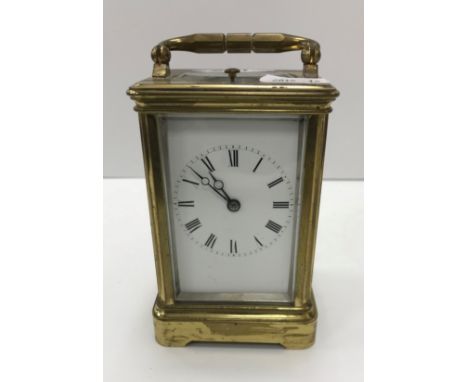 A circa 1900 French lacquered brass cased carriage clock, the white enamel dial with Roman numerals, the movement by Alfred D