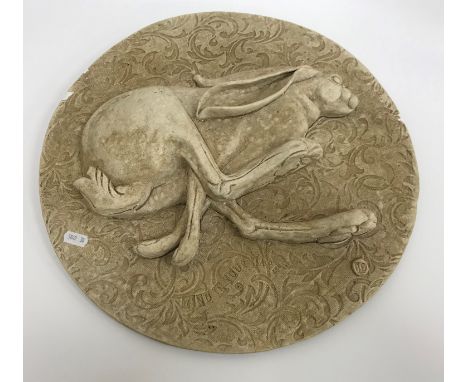AFTER GARRY JONES "Wind in your hare" a relief work plaque 41 cm diameter x 2, a similar plaque depicting three hares 29.5 cm