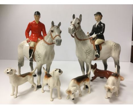 A Beswick hunting set comprising lady rider on horseback, gentleman on horseback, four hounds and fox together with rearing h