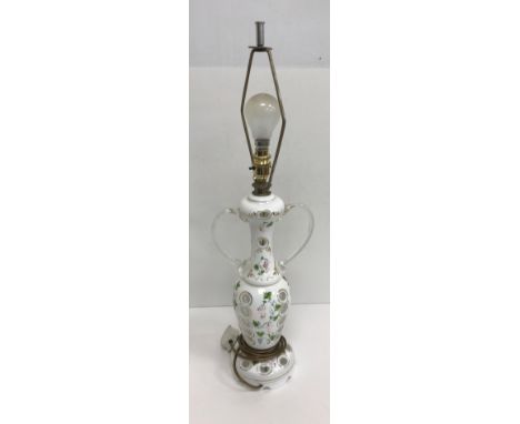 A circa 1900 Bohemian overlaid glass lamp of two handled urn form, the main body decorated with grape and vine and cut out pa