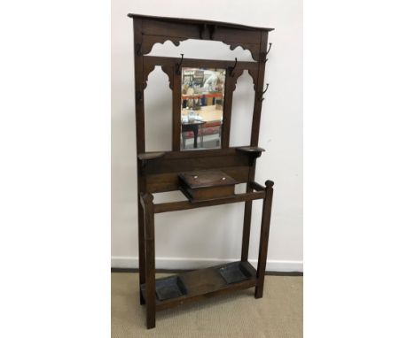 An early 20th Century oak hall stand with coat hooks and glove box flanked by stick stands 84 cm wide x 183 cm high and a sma