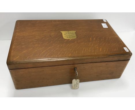 An oak cutlery canteen containing various plated cutlery with brass cartouche inscribed "Presented to R.W. Dawes by his frien