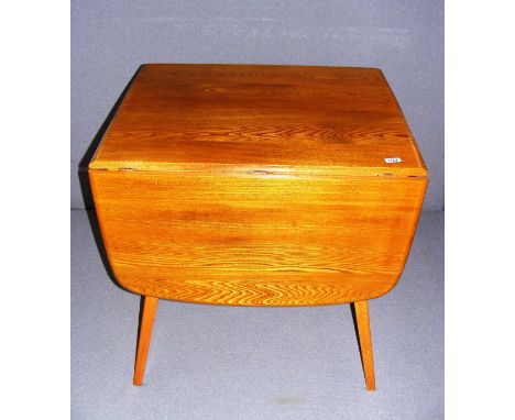 An Ercol table, measuring 53" long x 28" tall as a size guide.