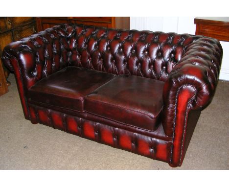 An oxblood Chesterfield button back sofa.