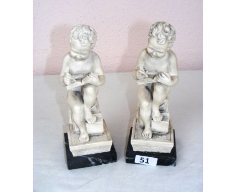 A pair of seated figurines reading a book, each measuring 9" tall as a size guide.