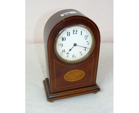 An Edwardian inlaid mantle clock on brass bun feet, in working condition, with a French movement, the case does have a nibble