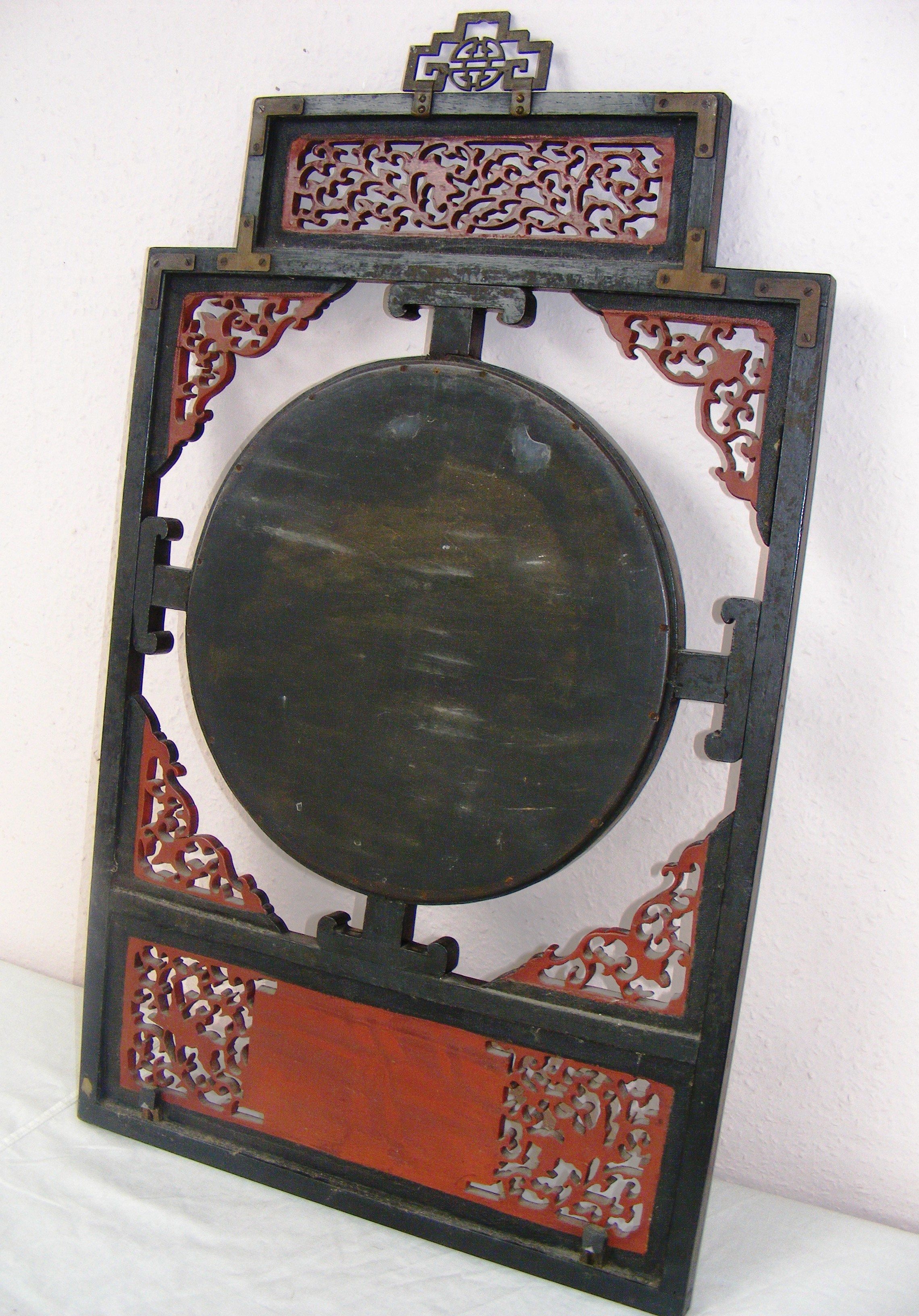 An early 20th century Japanese style mirror with figural carvings and