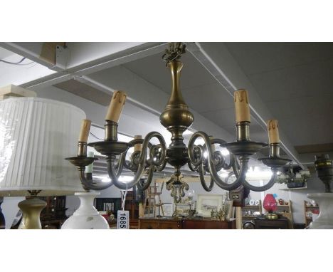 A 6 lamp brass ceiling light.