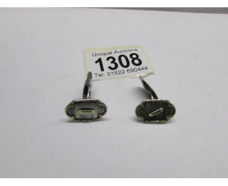 A pair of art deco silver cuff links.