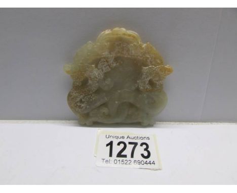 A carved and pierced jade amulet.