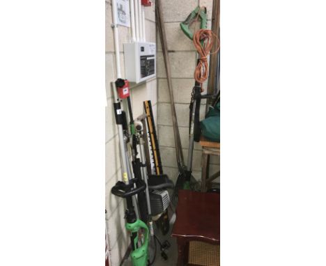 A number of garden hedge trimmers and hand tools