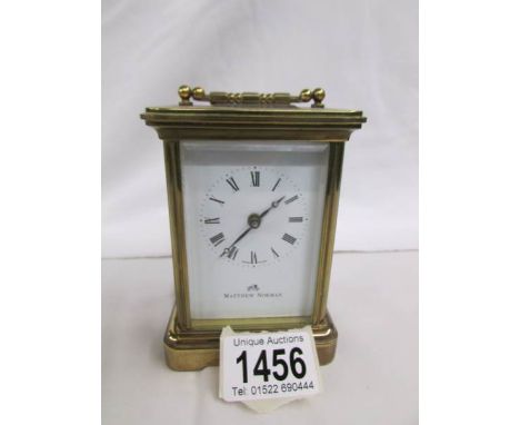 A Matthew Norman carriage clock with key.