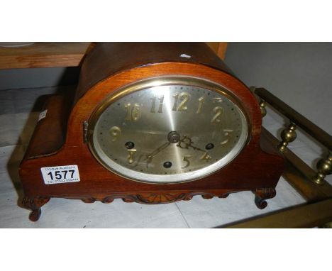 A Westminster chime mantel clock with key.