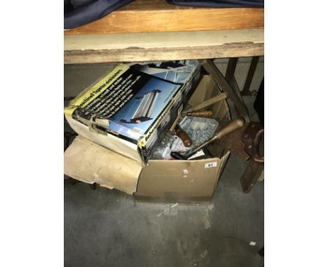 A box of old hand tools and a wallpapering aid