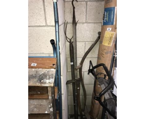 A quantity of vintage farming tools including sythe, pitch forks etc