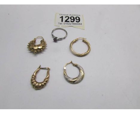 4 odd gold earrings and a silver ring.