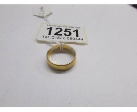 A wide 22ct gold wedding ring, size N.