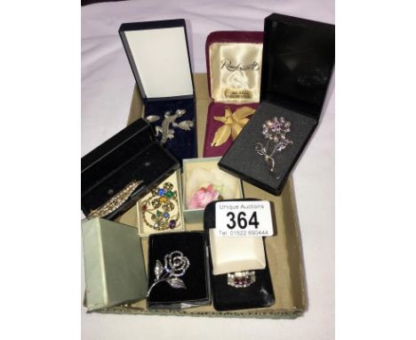 10 vintage costume brooches, a ring and a pair of earrings