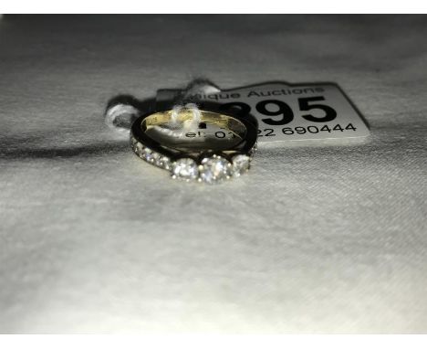 A 9ct gold ring set 3 diamonds and with diamond set shoulders, size M.