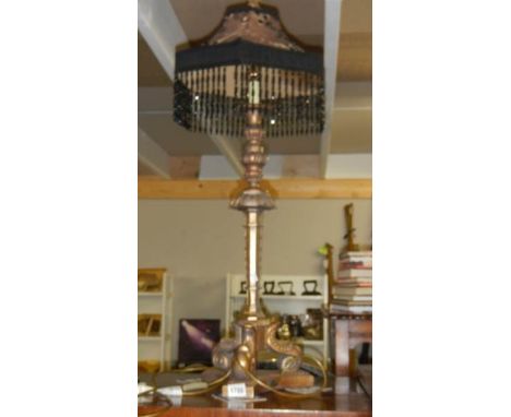A lamp with beaded shade.