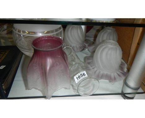 An acid etched cranberry glass lampshade, 3 matching glass lampshades, one other and an oil lamp chimney.