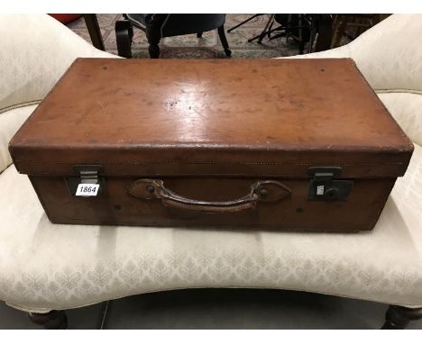 A large vintage leather suitcase.