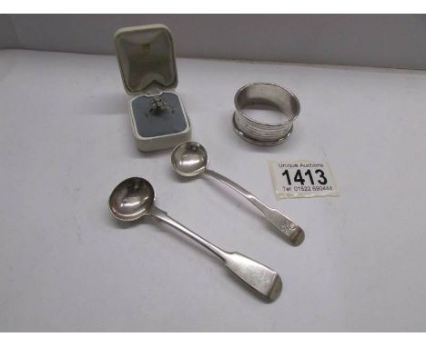 A silver napkin ring, 2 silver spoons and a silver ring.