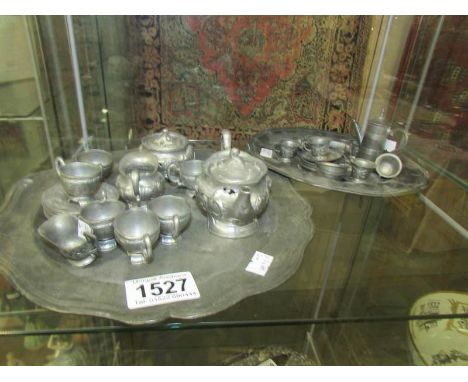 A 22 piece miniature pewter coffee set comprising tray, coffee pot, 2 sugar bowls, milk jug, 6 cups, 6 saucers and 5 spoons t