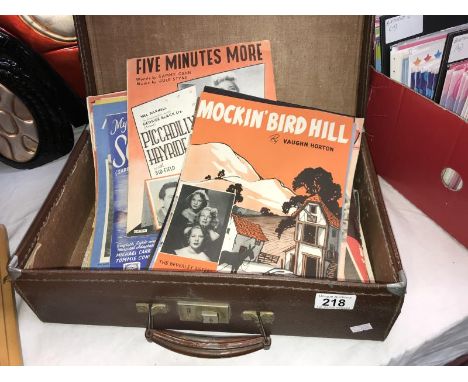 A vintage suitcase containing 1950's sheet music
