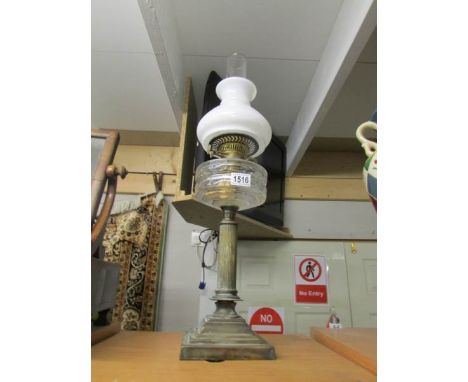 A Victorian column oil lamp with later shade and chimney.