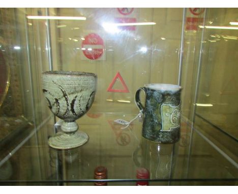 A Royal Doulton christening mug and an art pottery goblet.