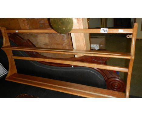 An Ercol wall hanging plate rack.