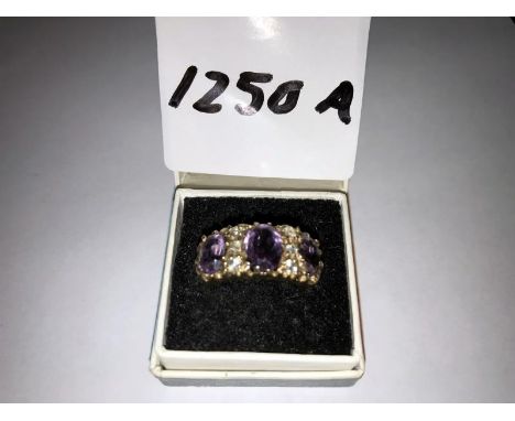 A 9ct gold ring set amethysts. Size M