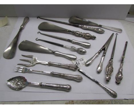 14 silver handled items including glove stretchers, button hooks, shoe horns, pickle fork etc.,