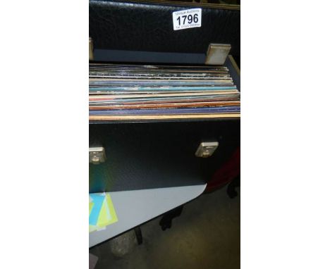 A box of LP records including Rolling Stones, David Bowie, John Lennon, Motown etc.,
