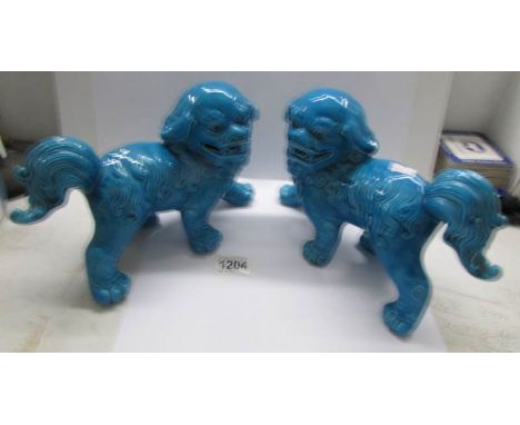 A pair of Chinese blue pottery 'Dogs of Foo'.