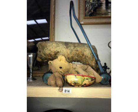 A vintage push-a-long bear on wheels and 3 other vintage bears
