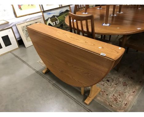 An Ercol drop leaf dining table.