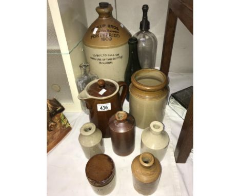 A collection of vintage bottles and earthen jars, jugs and bottles (some with brewers labelling)