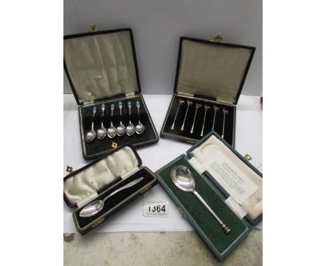 A cased set of 6 silver cocktail sticks CBirmingham 1937), a cased set of silver and enamel teaspoons (Gomms, Birmingham 1938