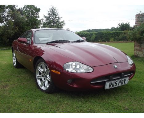 A 1998 Jaguar XK8, registration number R115 PBV, chassis number SAJJGAED3AR021507, engine number CC9711060147, red.  This wel