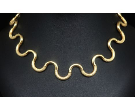 A stylish 18ct gold necklace of curve design with engine turned matt and gloss finish, marked 750, approx 26.7gms, purchased 