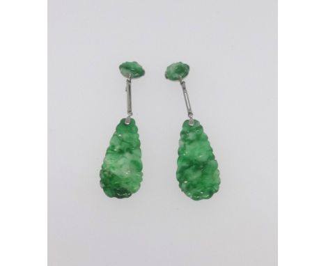 A pair of jade pendant earrings.