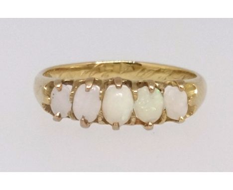 A Victorian five stone opal ring set in yellow gold with inscription and dated 1868, finger size M1/2.