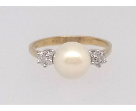 An 18ct pearl and diamond three stone ring, finger size N.