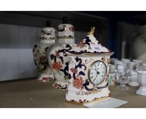 A Masons "Mandalay" patterned clock and a pair of Masons "Mandalay" patterned vases with covers