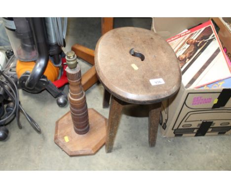 A wooden stool and turned wooden table lamp